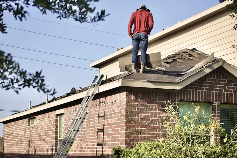Professional roofer working on a residential roof in South Solon